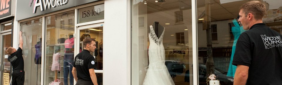 The Window Cleaning Company team cleaning shop windows in Northampton town centre